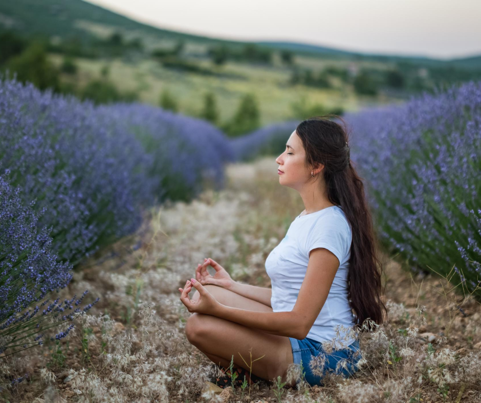 A woman meditating in a field