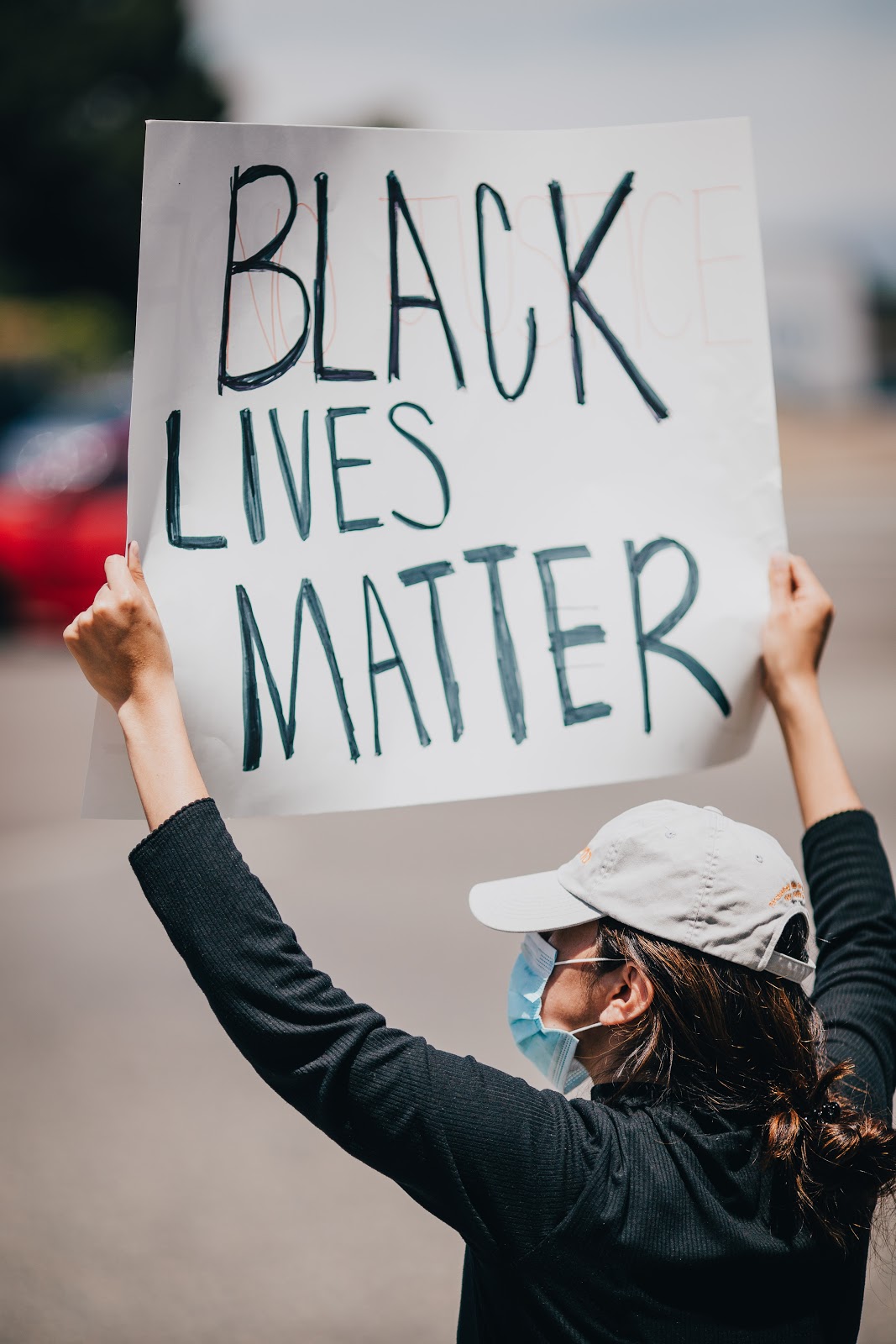 A woman raises a Black Lives Matter sign at a protest