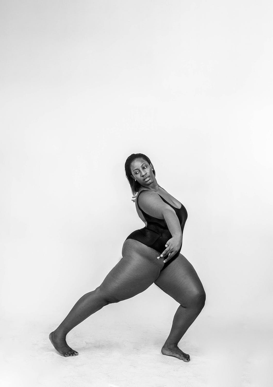 An empowered woman poses in the middle of a dance