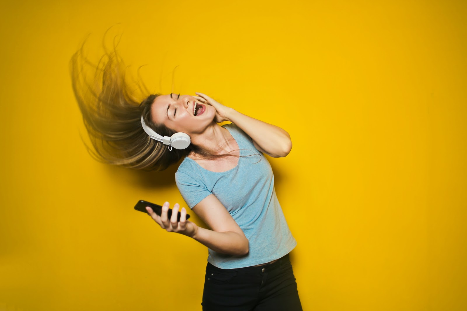 A women listens to music and looks free and happy