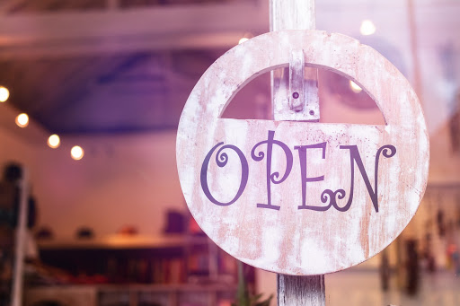 Preparing for a life after quarantine, a sign in a shop window reads that it is open